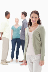 Obraz premium Woman smiling with her friends chatting behind