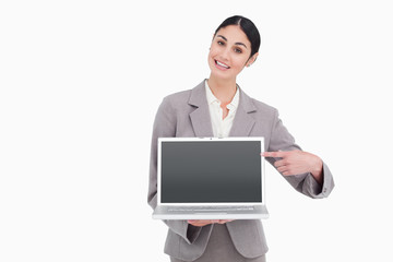 Businesswoman pointing at screen of her laptop