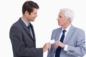 Close up of businessman giving business card to trades partner