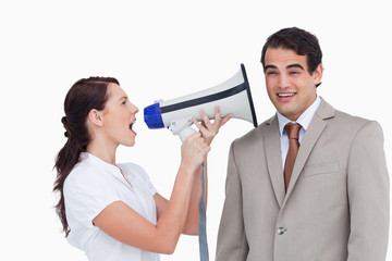 Saleswoman with megaphone yelling at colleague