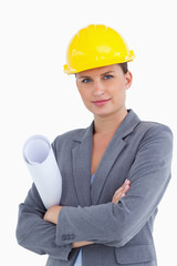 Close up of female architect with helmet and plans