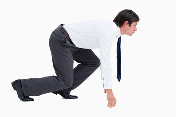 Side view of young tradesman in sprinting position