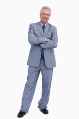 Smiling mature tradesman with his arms folded