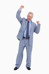 Cheering mature tradesman with arm risen