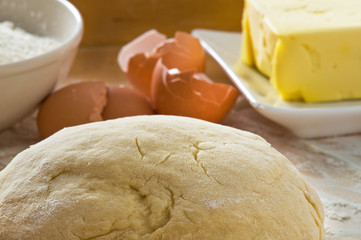 Dough on wooden board.