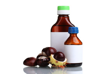 green and brown chestnuts and medical bottles isolated on white