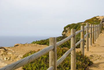 Fototapeta na wymiar Wooden fence on the cliff