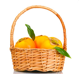 Appetizing persimmons with leaves in pad isolated on white