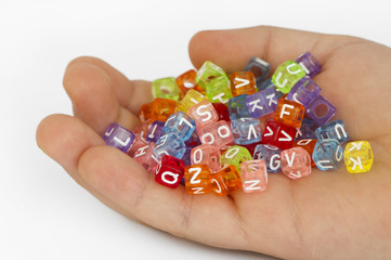 Children hand holding cubes with letters