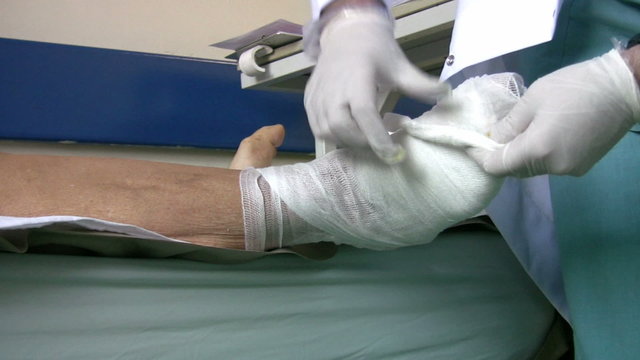 Doctor bandaging diabetic foot