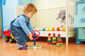 Boy playing with stacking rings