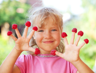 Little girl with raspberry