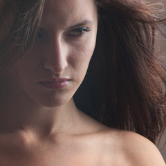 A beautiful girl with developing hairs looking sideways