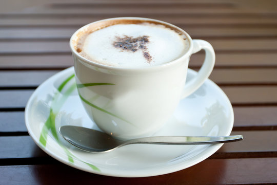 White cup cofee on wood table