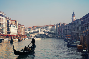 Fototapeta na wymiar Rialto Bridge and gondolas in Venice.