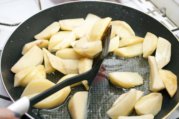 Fried potato on a frying pan