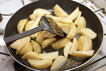 Fried potato on a frying pan