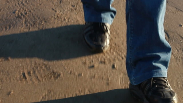 Walking on the beach, shoes close up