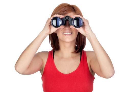 Beautiful redhead girl looking through binoculars