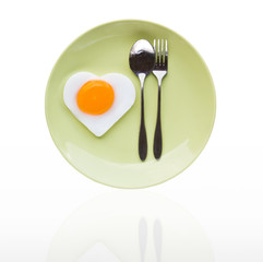 Fried egg heart and spoon