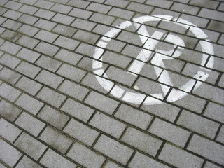 no parking sign sprayed in white on pavement