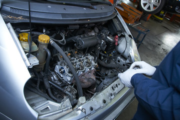 mechanic repairs a car in a garage