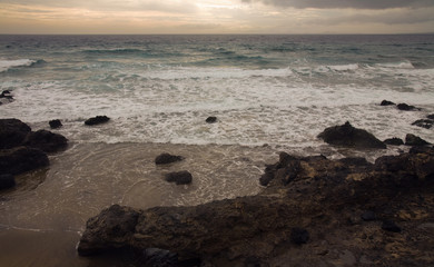 Shore of Lanzarote, wintry unsettled sea, outline of Fuerteventu