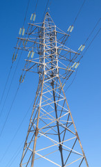 High-voltage power line metal prop  over blue sky
