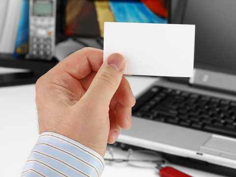 Male hand with blank business card
