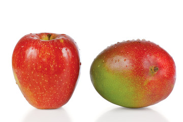 Fresh apple and mango with drops of water on a white background