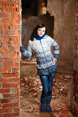 Brunette girl posing at abandoned ruins.