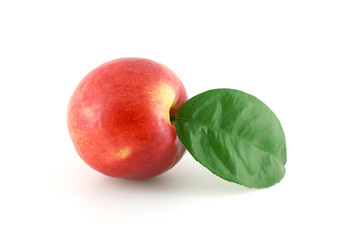 Ripe red apple with green leaf