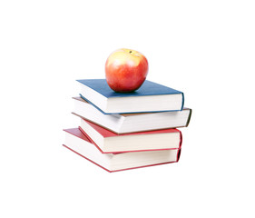 Four books on top of apples.