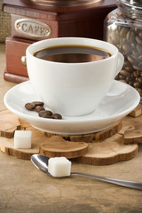 cup of coffee and grinder