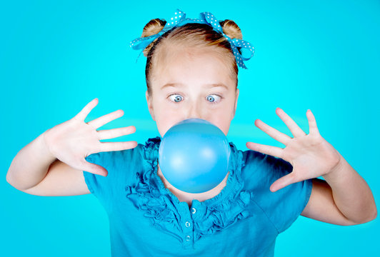 Silly girl blowing blue bubble