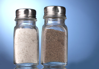 Salt and pepper mills on blue