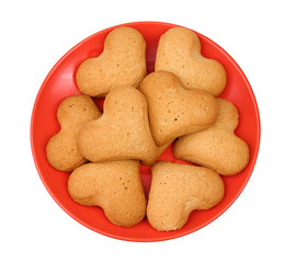 Heart-shaped cookies on red saucer isolated on white
