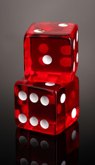 Red dices on grey background