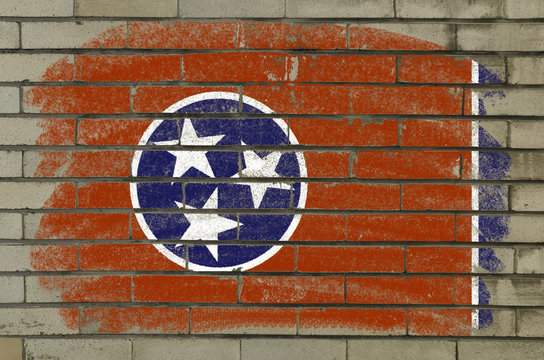 grunge flag of US state of tennessee on brick wall painted with
