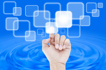 hand pushing a button on a touch screen interface