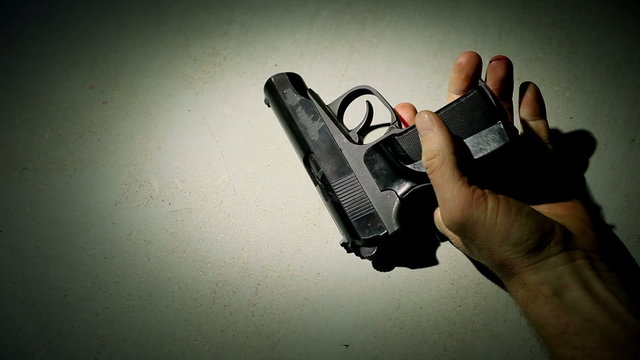 Falling hand with a pistol and red drops.