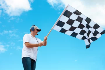 Fotobehang Man waving a checkered flag on a raceway © Monika Wisniewska