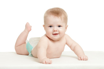 funny baby boy lying on tummy isolated on white background