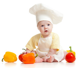 Portrait of a baby wearing a chef hat with healthy  food vegetab