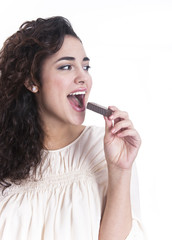 Happy young woman eating chocolate waffle