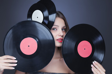 beautiful girl with vinil disc on black background
