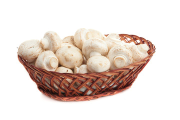 champignones in wooden basket isolated on white