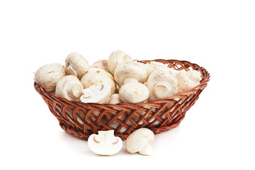 champignones in wooden basket isolated on white
