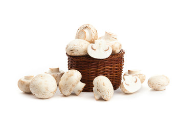 champignones in wooden basket isolated on white