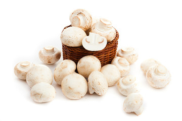 champignones in wooden basket isolated on white
